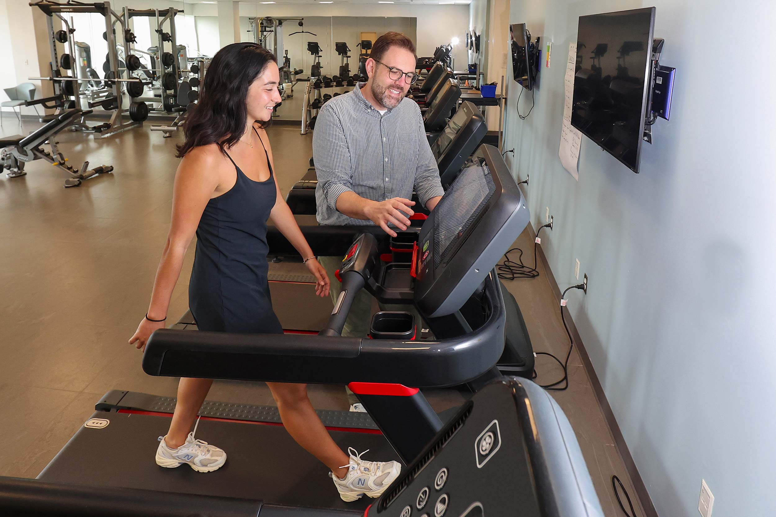 A researcher works with a participant on a treadmill as part of post-ACL recovery research